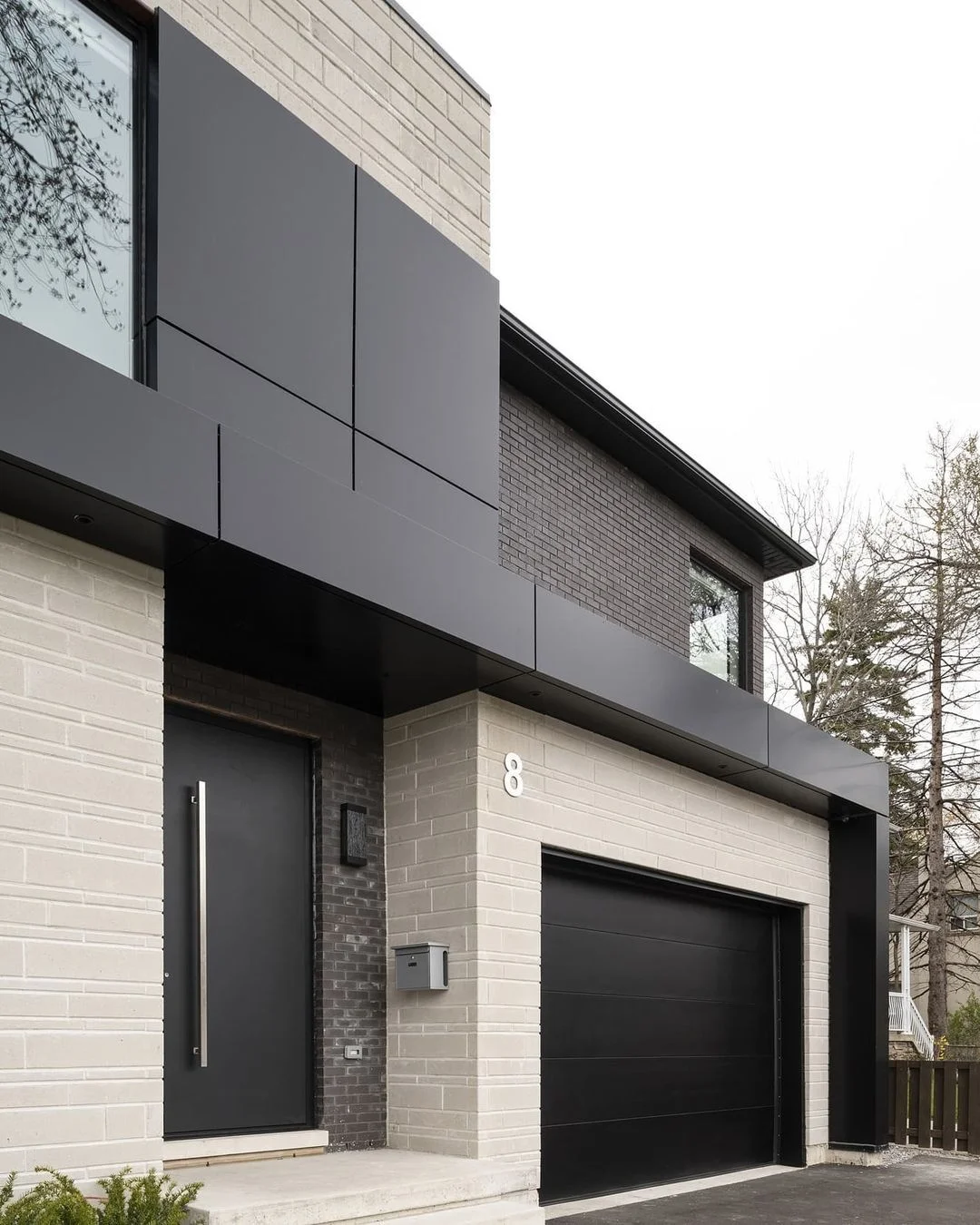 Black and White Modern Home with Bold Garage Door Design